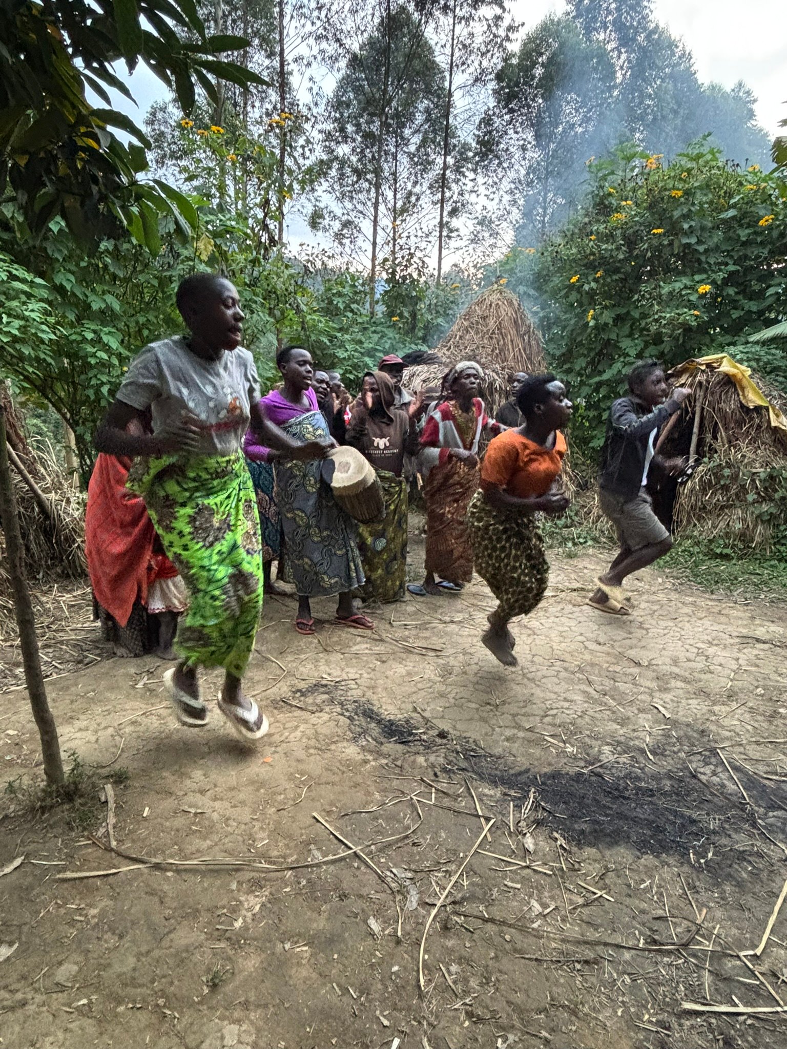 cultural tours Uganda – travelers joining community dances with Amatsiko Tours